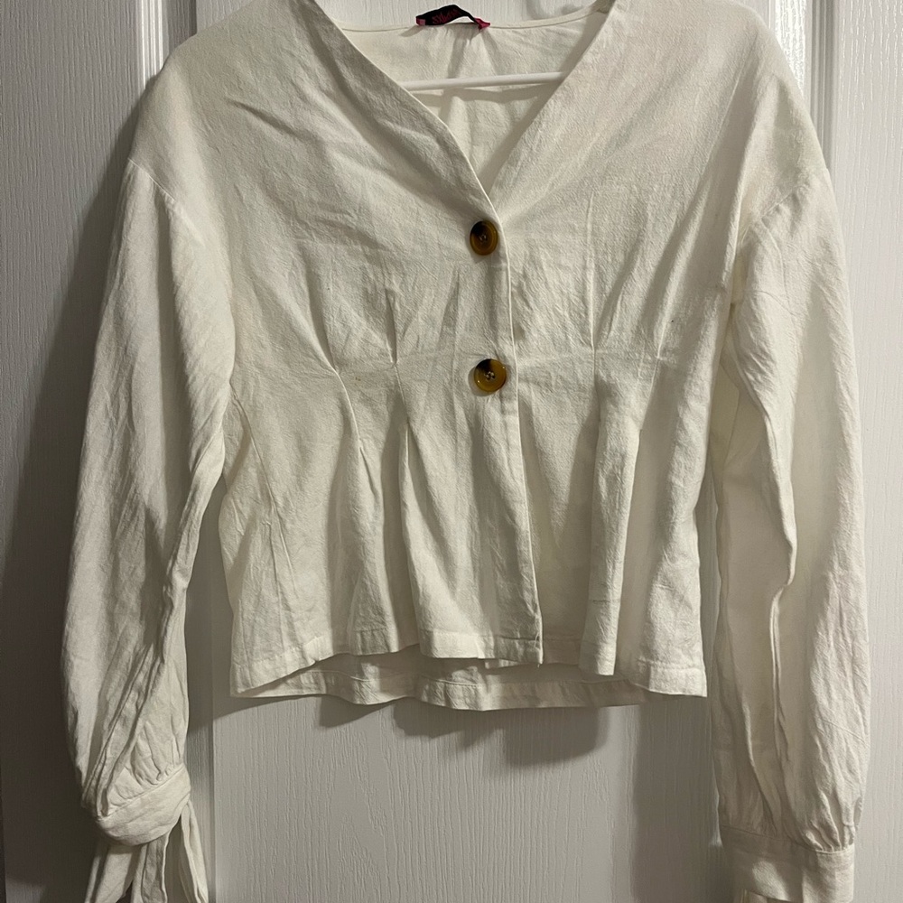 Fitted white button up shirt with tie-able strings on the ends of the sleeves.